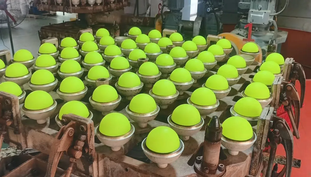 Demolding freshly formed one-piece seamless rotomolded pickleball shells from high temperature metal molds