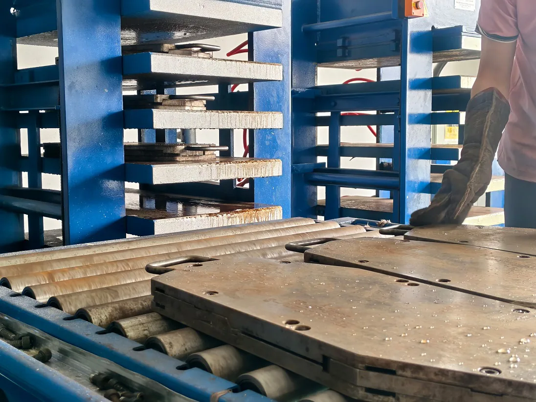 Loading pre-assembled carbon fiber pickleball paddle into steel hot press mold for unibody thermoforming