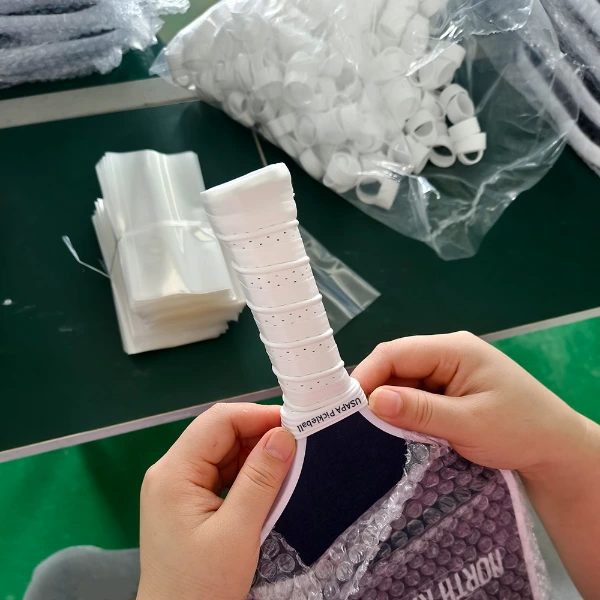 Securing handle grip tape with custom branded flexible silicone rubber collar ring on paddle neck